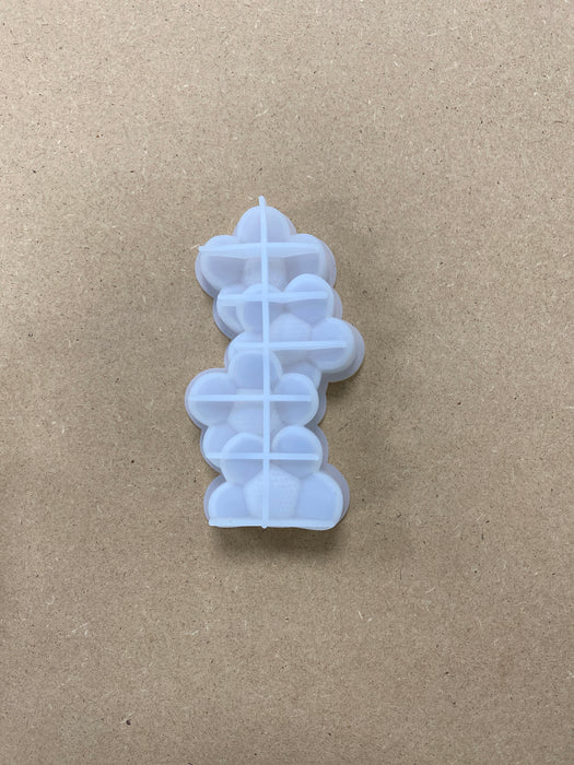 Stacks of Heart and Flower Shaped Candle Mold
