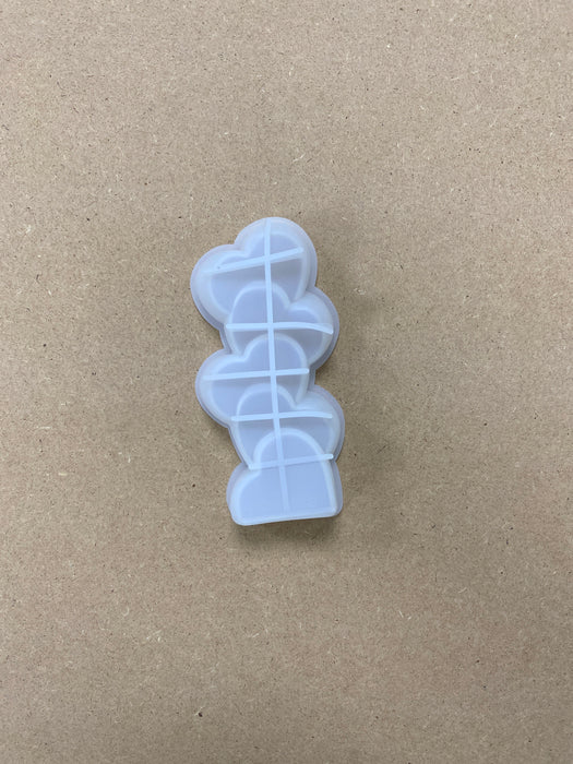 Stacks of Heart and Flower Shaped Candle Mold